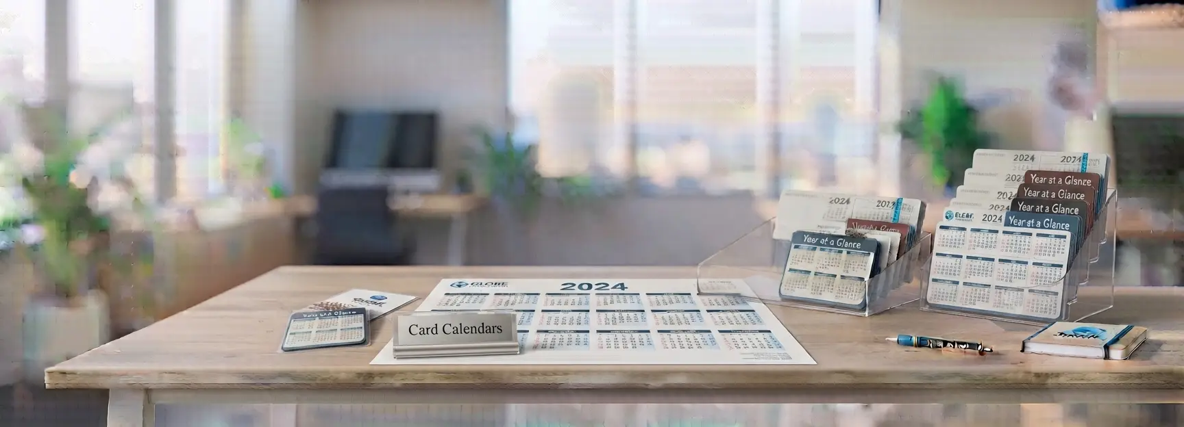 Custom card calendars and wallet-size laminated calendars displayed on a professional office desk
